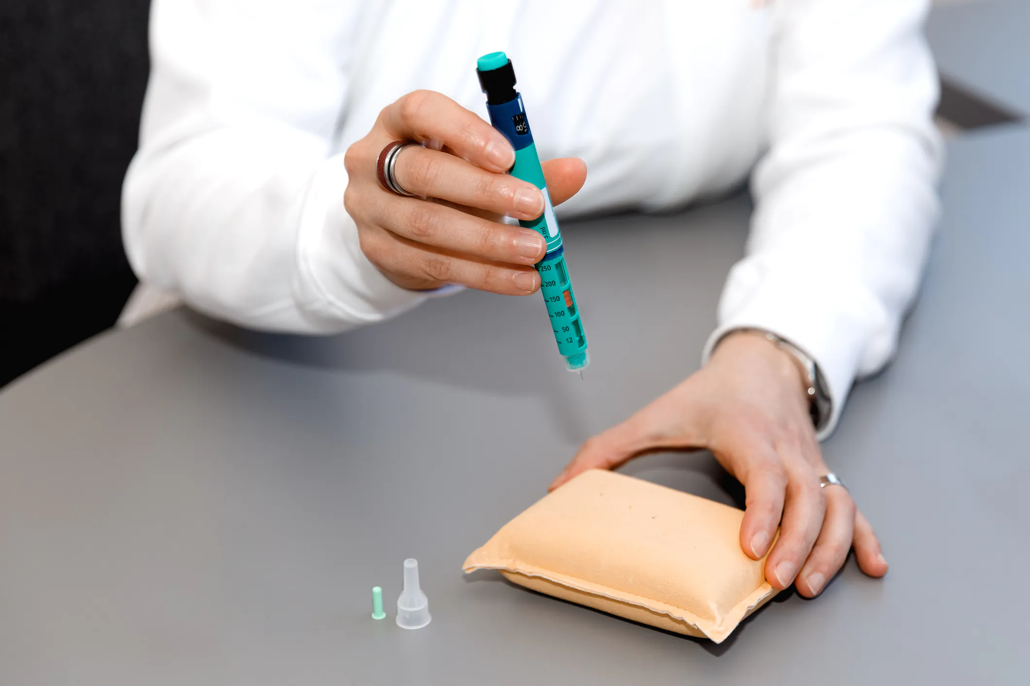 Person performing a diabetes test on practice pad.