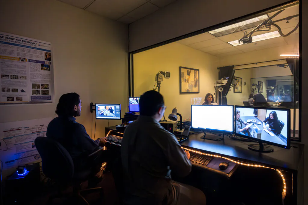 two people watching a study from a viewing room