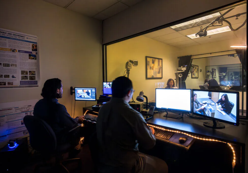 two people watching a study from a viewing room