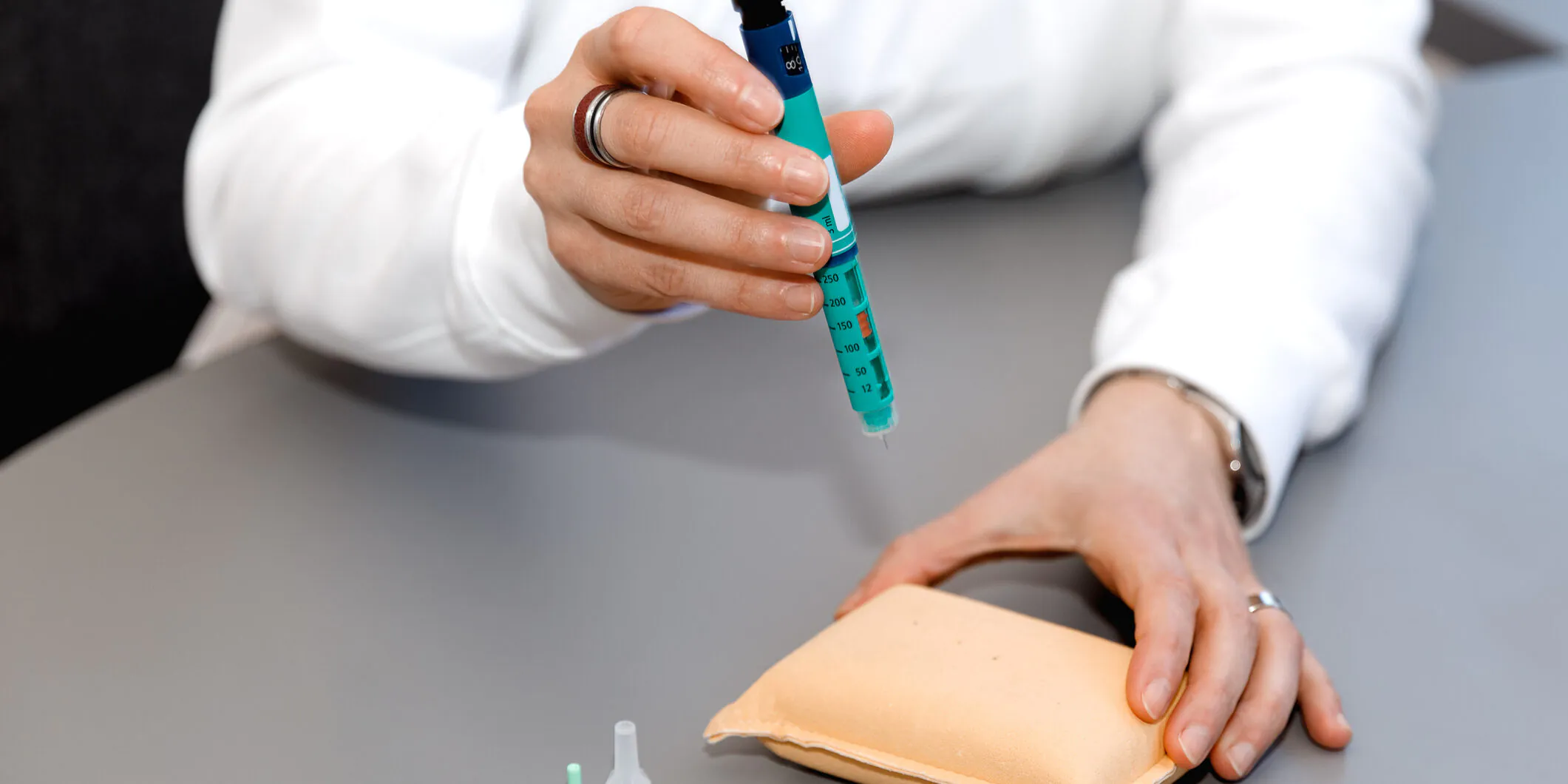 Person performing a diabetes test on practice pad.